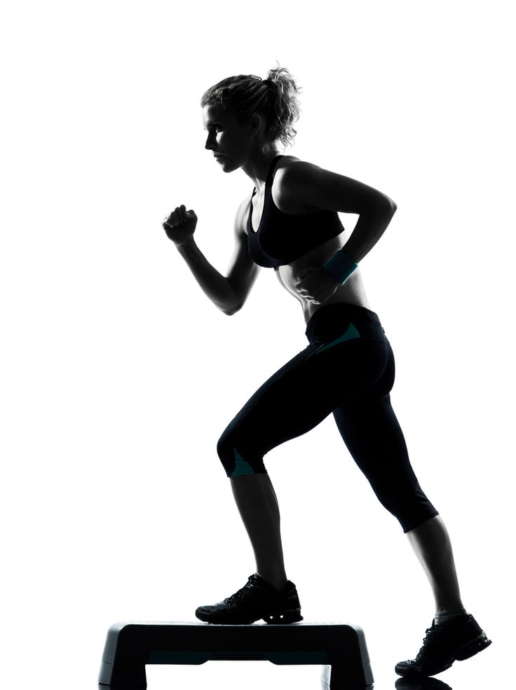 a woman is running on a treadmill silhouetted against a white background with the shadow of her leggings