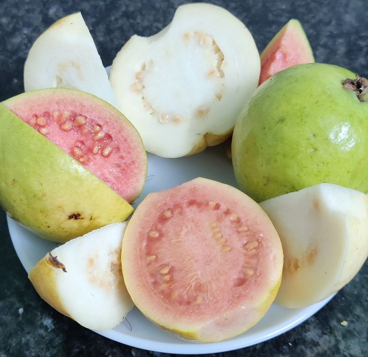 a white plate topped with pieces of fruit