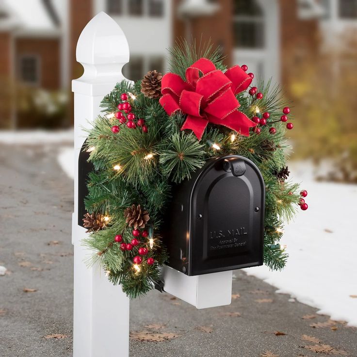 a mailbox decorated with christmas decorations and lights