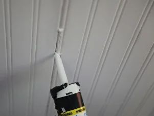 a black and white toothbrush sticking out of the ceiling