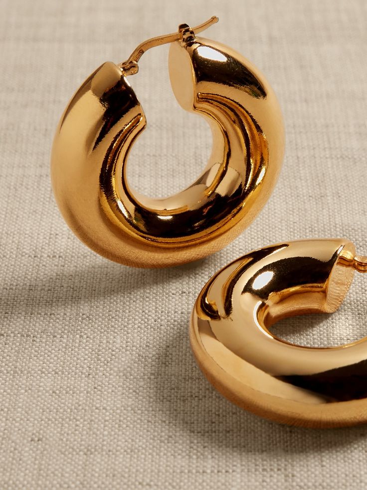 Perfectly-sized polished hoops with a plump profile and hollow core are made of bronze.  Timeless Classics: Luxury, everyday.  A showcase of time-honored craftsmanship and skilled Italian artisans, these are the pieces you'll reach for season after season, delighting in their exceptional versatility and endless appeal.  Hinged post backs.  12K-gold plated or silver-plated bronze.  Made in Italy.  Length: 1. 5" Luxury Black Wedge Sandals With Stacked Heel, Luxury Stacked Heel Sandals For Wedding, Luxury Italian Craftsmanship Timeless Dress Shoes, Luxury Timeless Black Dress Shoes, Luxury Hoop Earrings From Macy's, Chuncky Gold Hoop Earrings, Luxury Wedge Sandals With Stacked Heel, Luxury Timeless Italian Dress Shoes, Jennifer Lopez Hoop Earrings