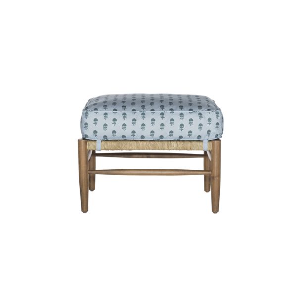 the foot stool is made from wood and has a blue patterned seat cover on it