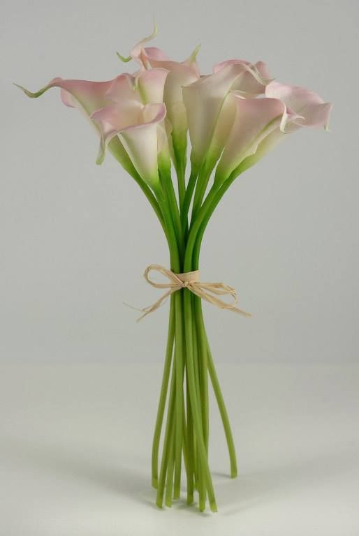 pink and white flowers are tied up in a vase with green stems on the side