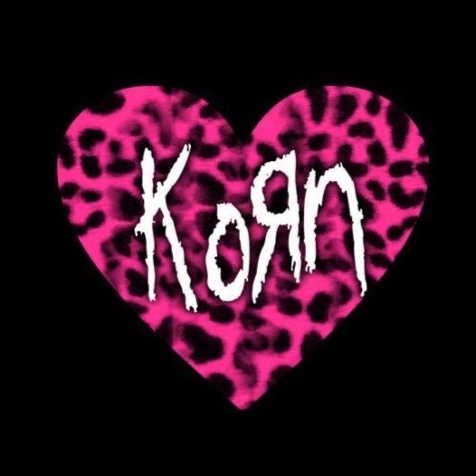 a heart with the word korn painted on it's side in pink and black