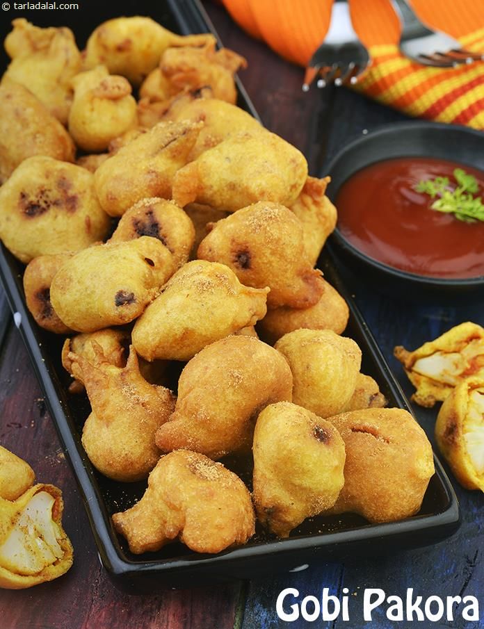 fried food items displayed on serving trays with dipping sauce