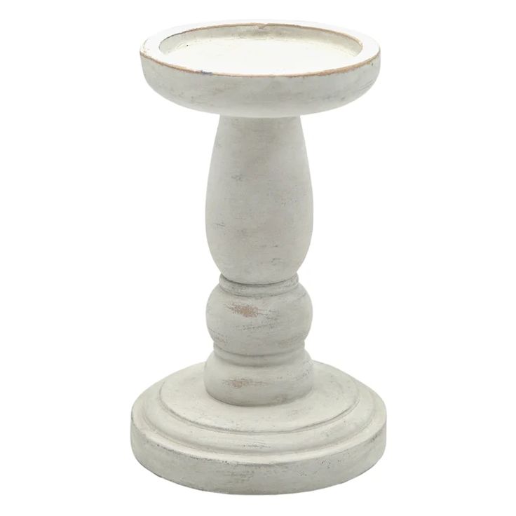 a white candle holder on a pedestal with no candles in the top and bottom part