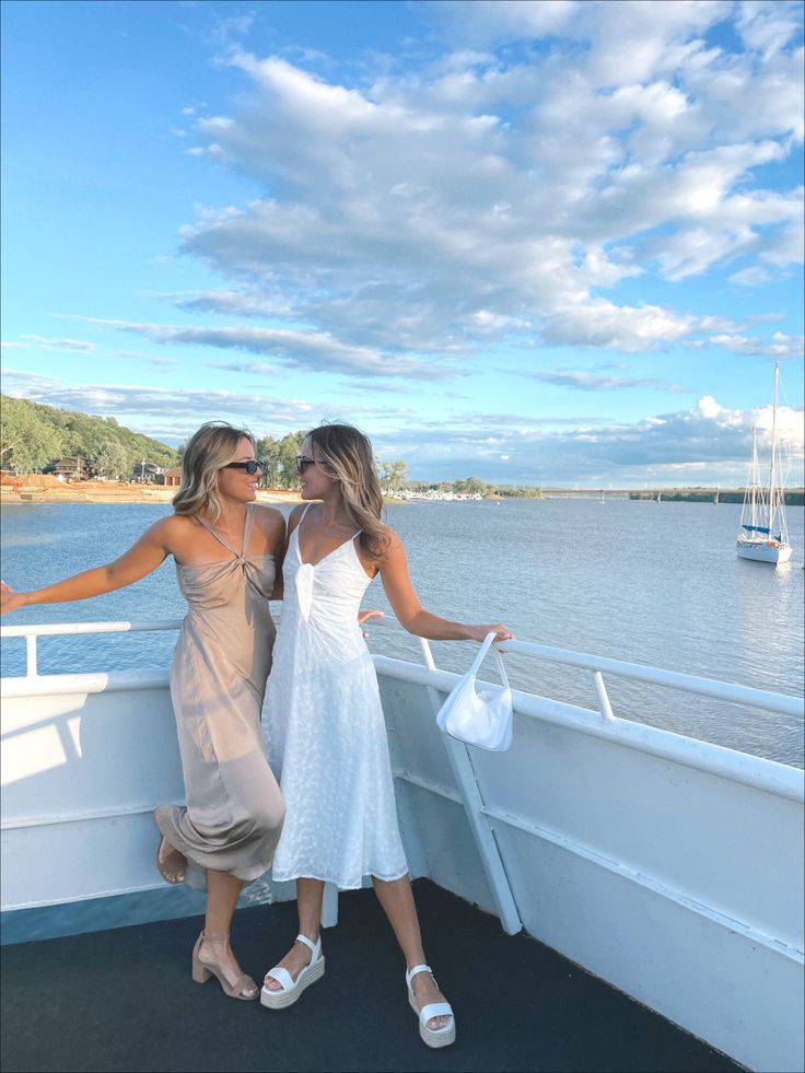 two women standing on the deck of a boat