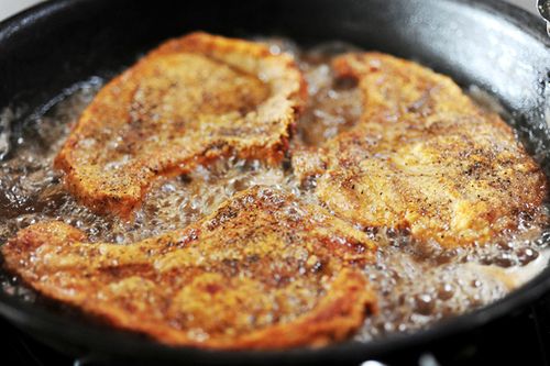 two pieces of fried food cooking in a frying pan