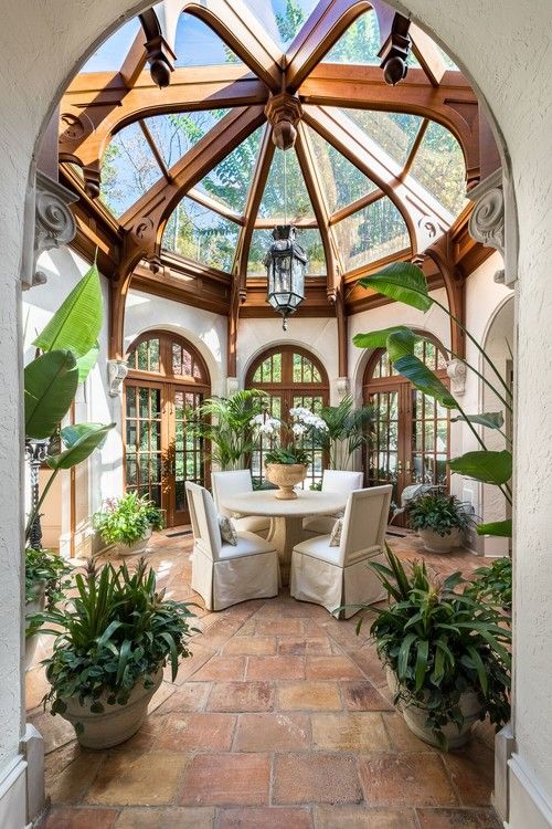 the inside of a house with lots of plants