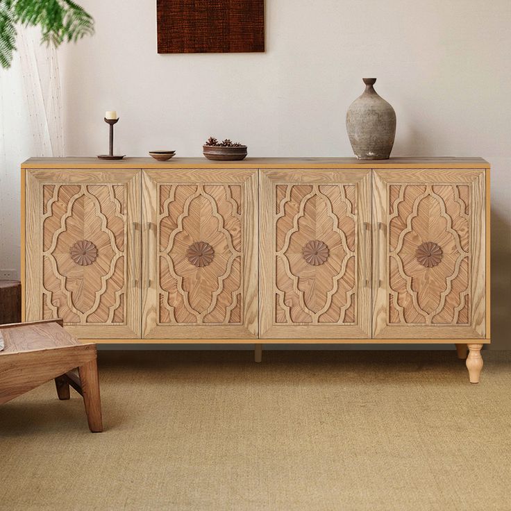 a large wooden cabinet sitting in a living room next to a vase and table on top of a rug