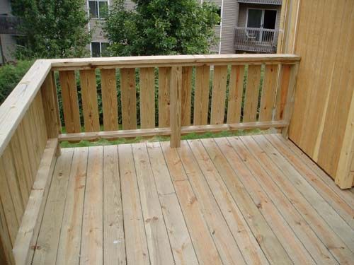 a wooden deck in front of a building