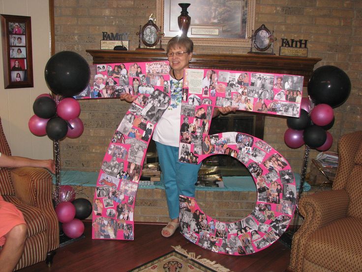 a woman standing in front of a large number with balloons