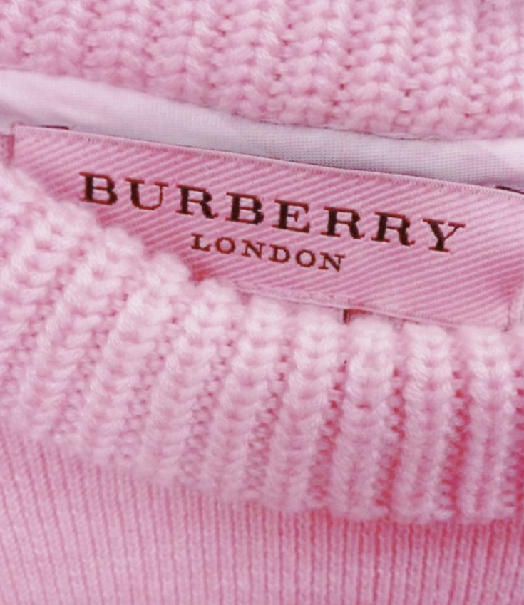 a pink sweater with the label on it that says burbery london in english