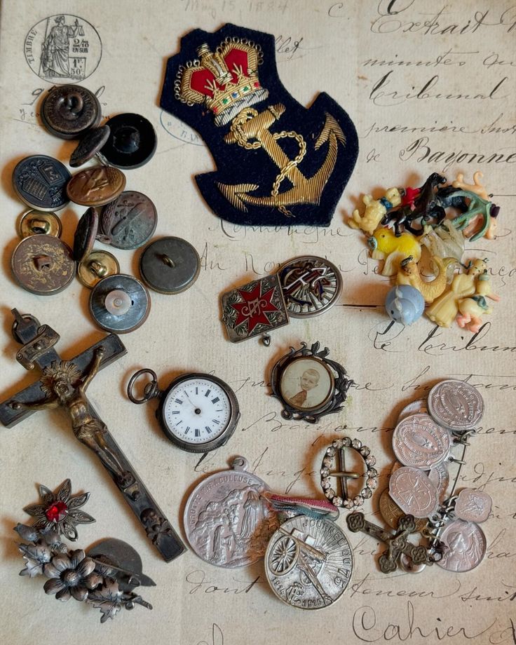 an assortment of antique and vintage items are displayed on a piece of paper with writing in the background