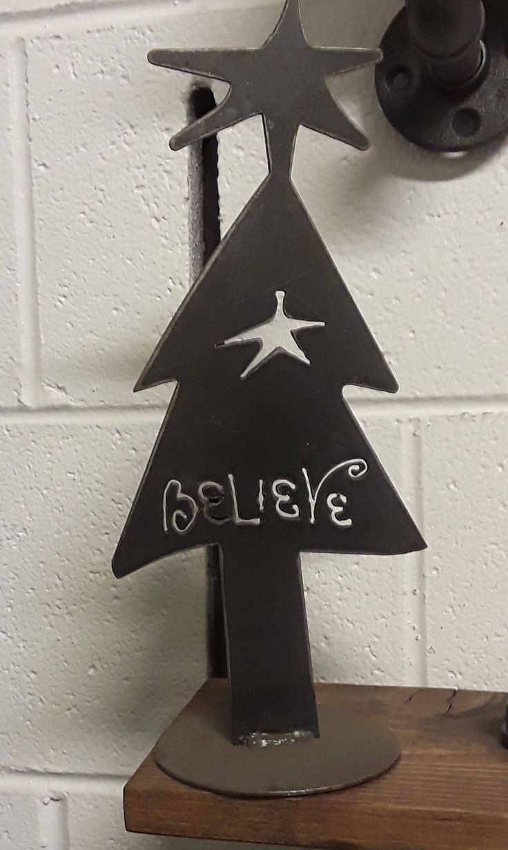 a metal christmas tree on a wooden shelf