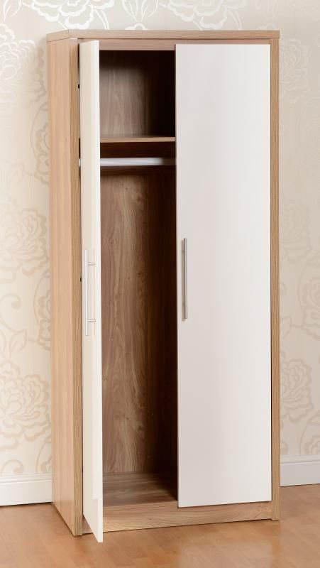 a white and wood cabinet sitting on top of a hard wood floor next to a wall