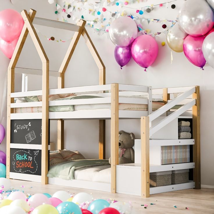 a room with balloons and wooden bunk beds