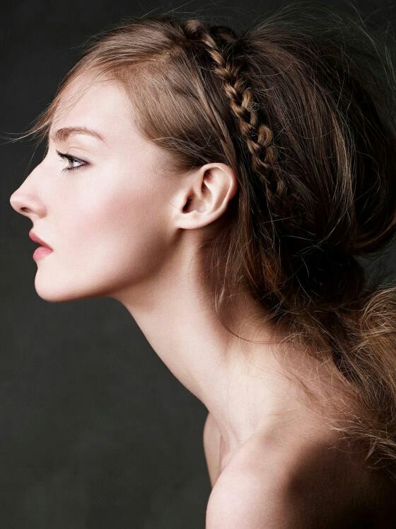 a woman with long hair and braids on her head