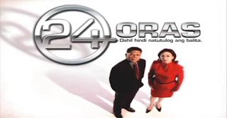 two people standing next to each other in front of a sign that says 24 oras