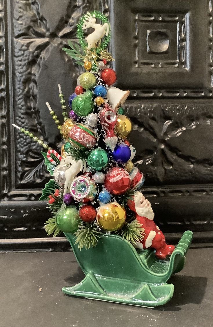 a small christmas tree with ornaments on it