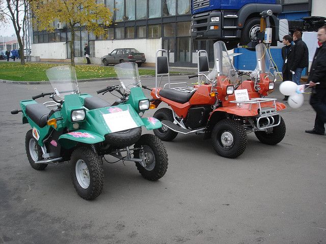 two motorcycles parked next to each other in a parking lot