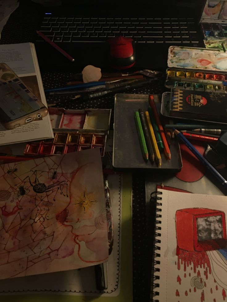 there are many art supplies on the desk