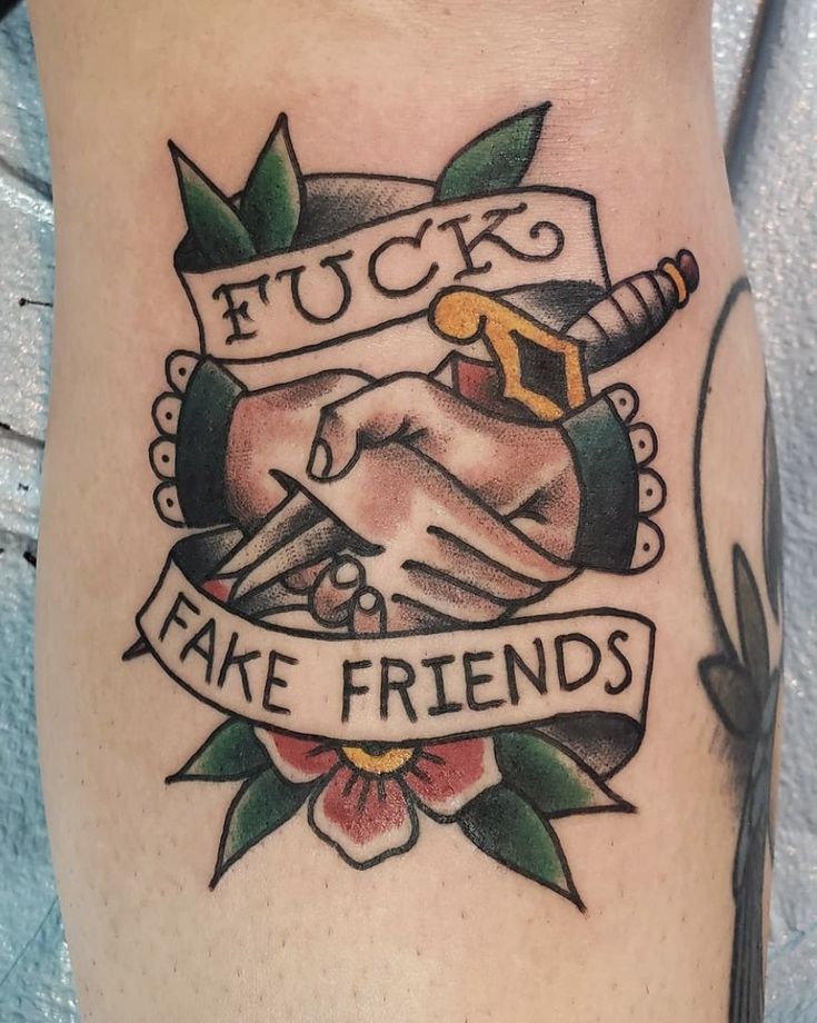 a close up of a tattoo on the leg of a person with tattoos and words