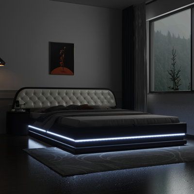 a bed that is sitting in the middle of a room with a light on it