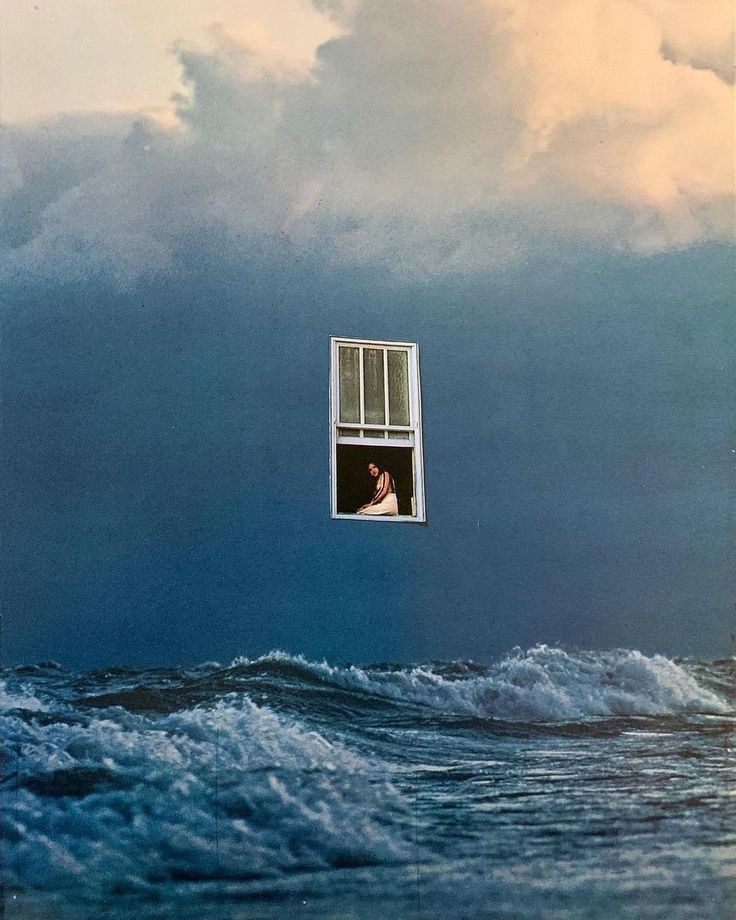 an image of a man looking out the window at the ocean with storm clouds in the background