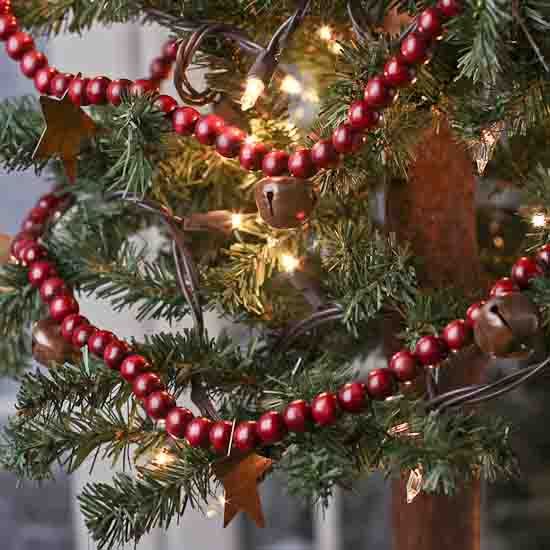 a christmas tree decorated with red and gold bauble beads, lights and ornaments