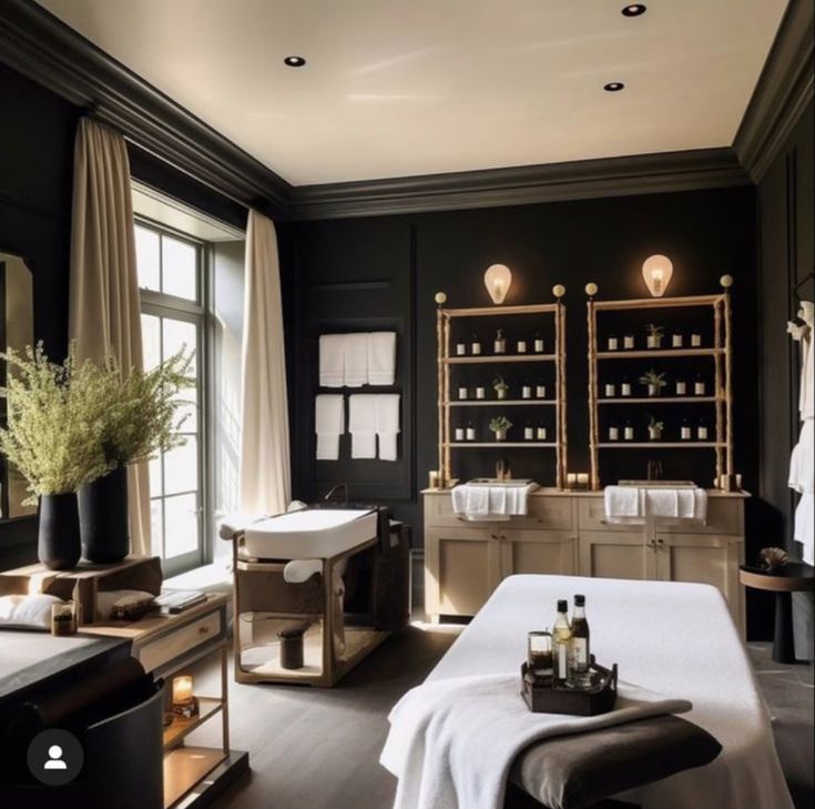 a spa room with black walls and wooden floors