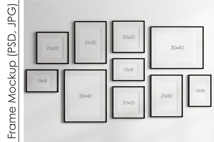 a white wall with black framed pictures on it and numbers in the frames above them