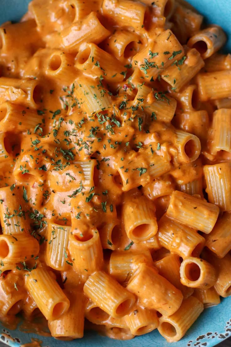 a blue bowl filled with macaroni and cheese