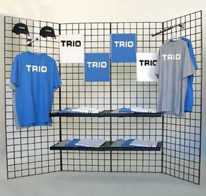 a display with t - shirts and hats on shelves