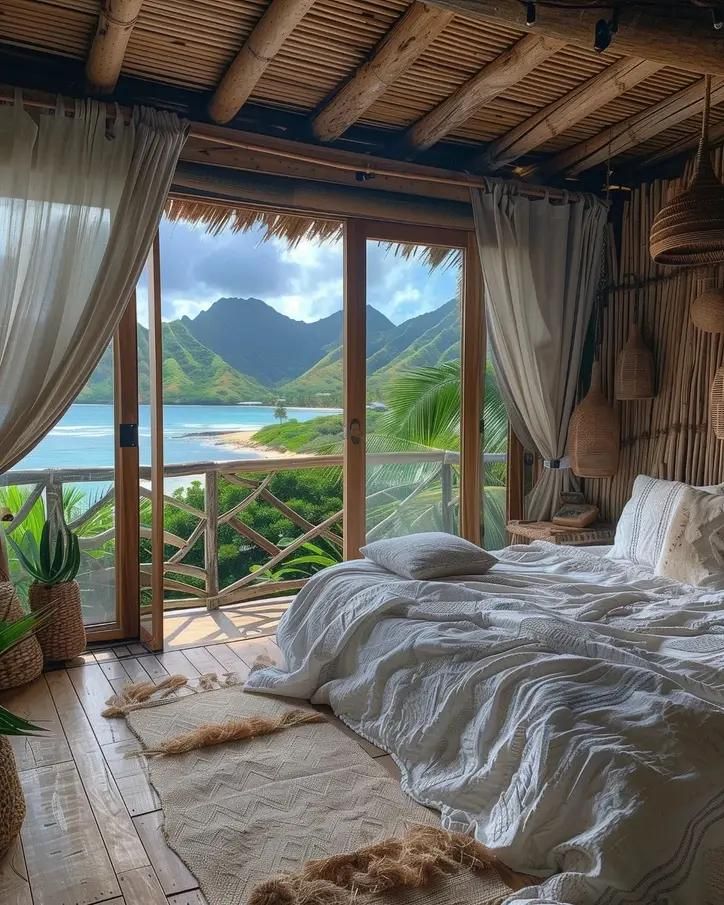 a large bed sitting in a bedroom next to a window with an ocean view on the other side