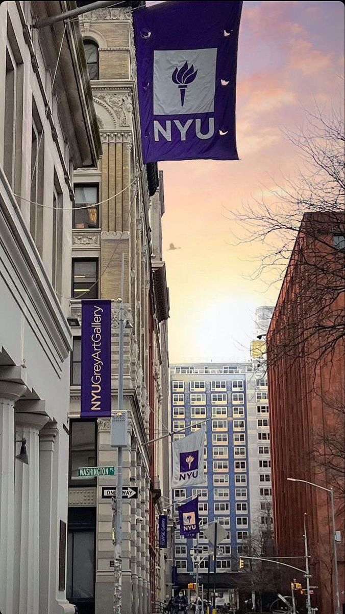 a city street lined with tall buildings and banners