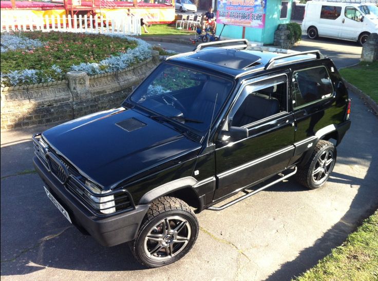 a black suv parked on the side of a road