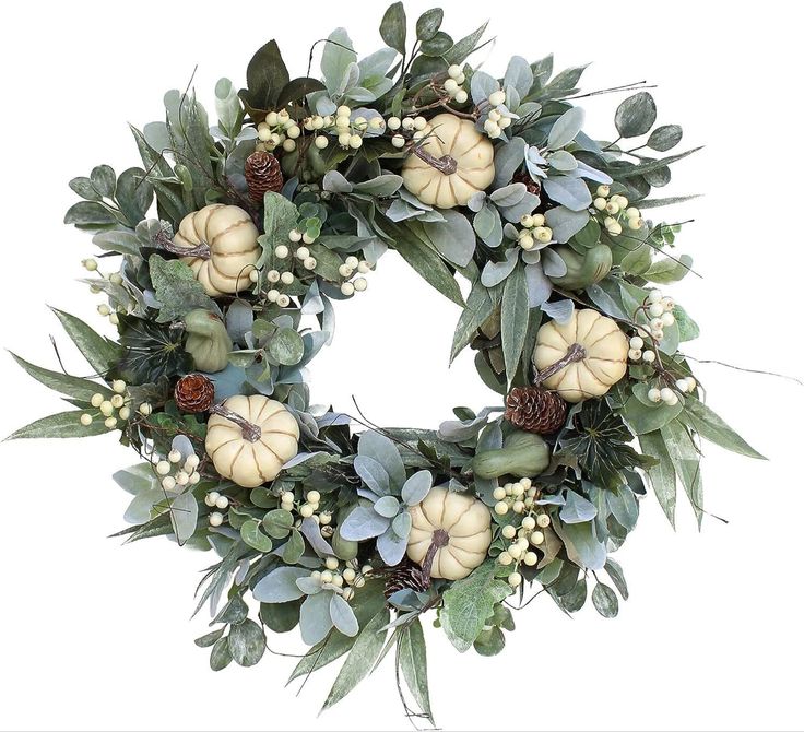 a wreath with white pumpkins and greenery on it is displayed against a white background