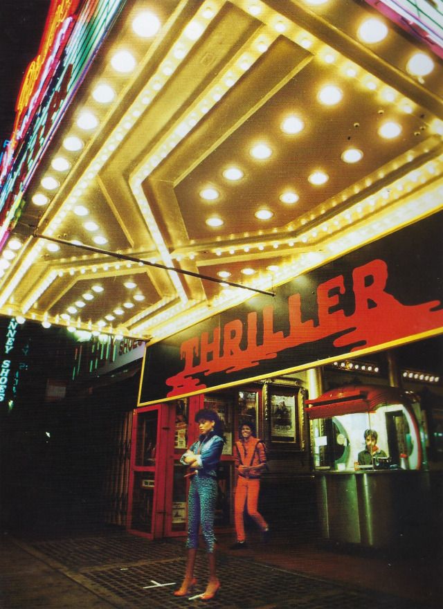 two people are standing in front of a theater sign that reads'thiller '