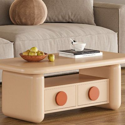 a coffee table with some fruit on it and a bowl of apples in the middle