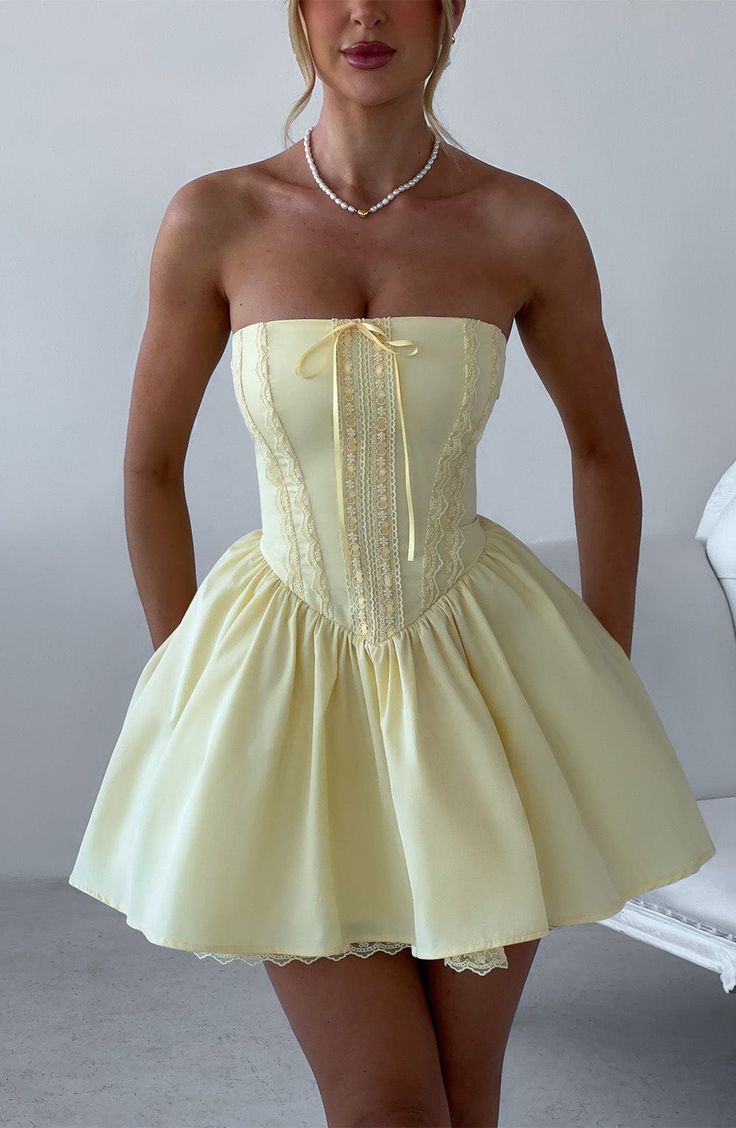 Fall in love with the Evie dress, a flirty mini with a super full skirt made with tulle for extra volume. This strapless style has a boned bodice for an extra snatched look, complete with ribbon to the bust and lace up back. Dress her up with effortless waves, pointed heels and metallic jewellery.



Colour: Lemon.

Non-stretch cotton blend fabric.

Fully lined.

Full skirt with tulle and gathered detail at waist.

Boned bodice with v-shape hem.

Strapless.

Ribbon tie at bust.

Lace trim detail Short Birthday Dress, 21st Birthday Dress, Homecoming Dresses Satin, Vestidos Color Vino, Strapless Homecoming Dresses, Dinner Dresses, Dresses Satin, Maxi Dress Sale, Party Gown