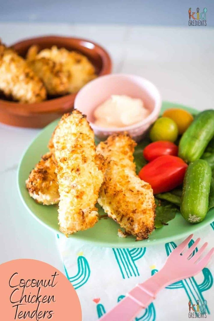 chicken tenders on a plate with vegetables and dip