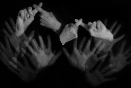 black and white photograph of hands reaching up to each other with the words computer friends in sign language read johnie bruner