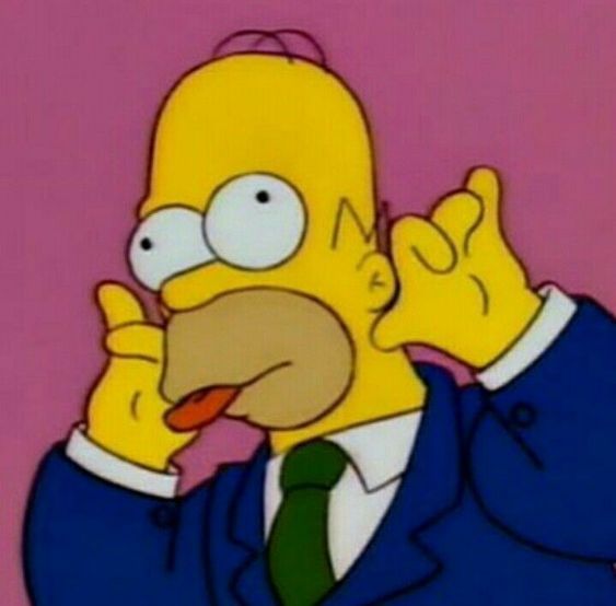 the simpsons is talking on his cell phone while wearing a suit and tie with one hand up to his ear