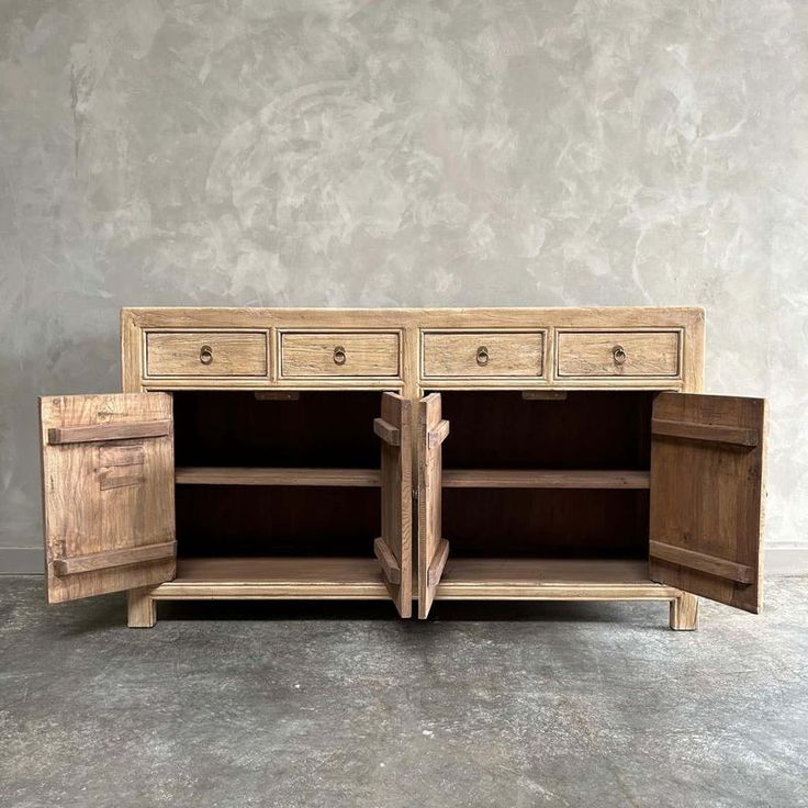 an old wooden cabinet with two drawers and one door open to reveal the inside space