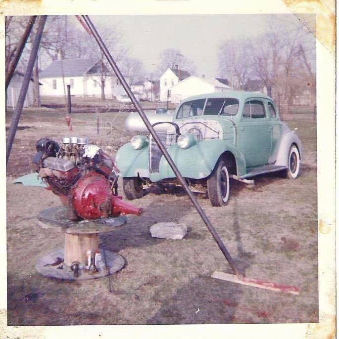 an old car is parked next to a fire hydrant