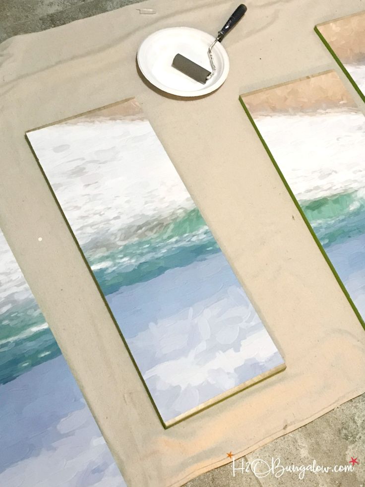 a table with two mirrors and a plate on it next to a wall that has been painted