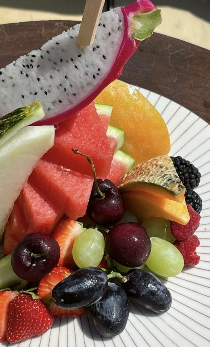 a white plate topped with lots of different types of fruit