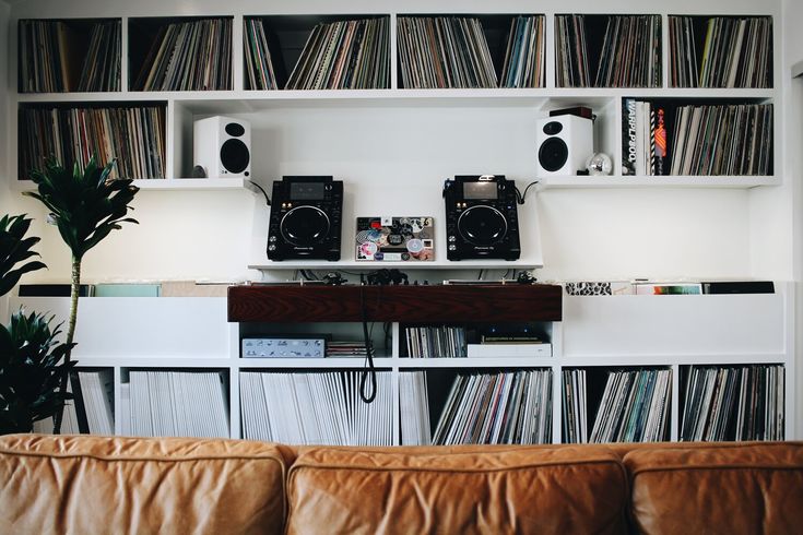 a living room filled with furniture and lots of records