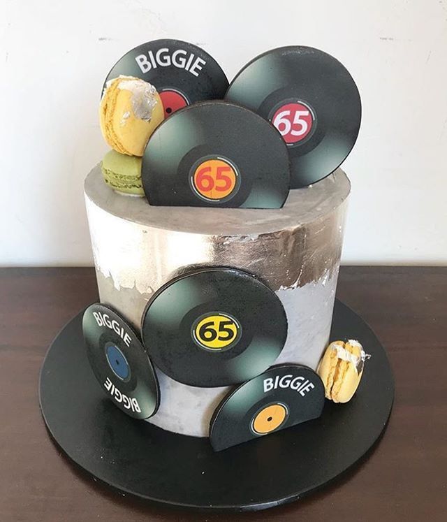 a birthday cake made to look like an old record player's hat with the number 55 on it